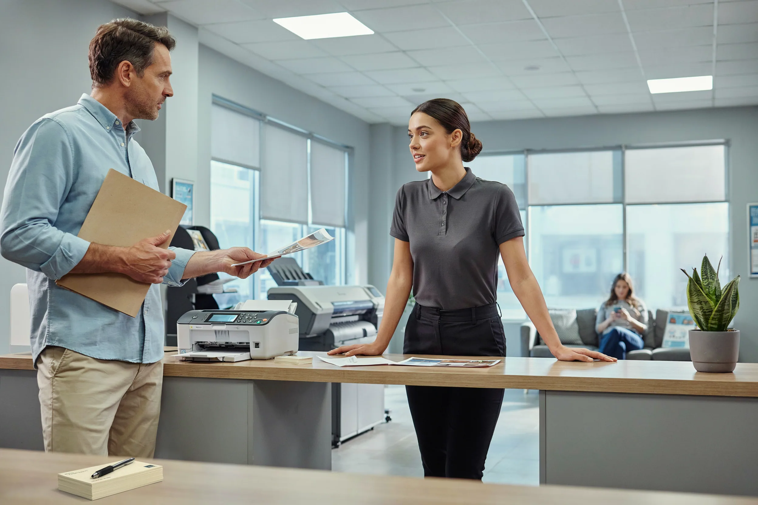 copy shop counter with a small fax machine visible, a clerk assisting a customer